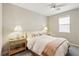 Neutral bedroom with a neatly made bed, a ceiling fan, and two bedside tables with lamps, creating a peaceful retreat at 10196 Sequoia Glen Ave, Las Vegas, NV 89166