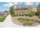 A stone entrance monument displays the community name amidst lush landscaping and a sidewalk at 10196 Sequoia Glen Ave, Las Vegas, NV 89166