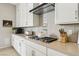 Kitchen boasts white cabinets, stainless appliances, and light countertops at 10196 Sequoia Glen Ave, Las Vegas, NV 89166