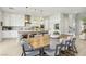 Well-lit kitchen with a long center island, modern appliances, white cabinets, and space for seating and dining at 10196 Sequoia Glen Ave, Las Vegas, NV 89166