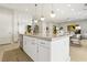 Open concept kitchen area with a large center island, stainless steel appliances, and a seamless transition to the living area at 10196 Sequoia Glen Ave, Las Vegas, NV 89166