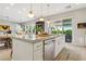 Modern kitchen featuring a center island, stainless appliances, and an open design leading to an outdoor dining area at 10196 Sequoia Glen Ave, Las Vegas, NV 89166