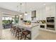 Modern kitchen featuring sleek countertops, a center island, white cabinetry and an outdoor patio for al fresco dining at 10196 Sequoia Glen Ave, Las Vegas, NV 89166
