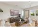 Comfortable living room with modern furnishings, stylish accents, and ample natural light, perfect for relaxation and entertaining at 10196 Sequoia Glen Ave, Las Vegas, NV 89166