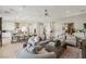 Open-concept living area with plush seating, modern decor, and seamless flow into the dining and kitchen spaces at 10196 Sequoia Glen Ave, Las Vegas, NV 89166