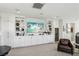 Bright living room with white built-ins, shelving, and a dedicated wine fridge for entertaining at 10196 Sequoia Glen Ave, Las Vegas, NV 89166