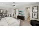Bright primary bedroom with plush carpet, windows, and an ensuite at 10196 Sequoia Glen Ave, Las Vegas, NV 89166