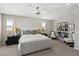Primary bedroom with plush carpet, windows, ceiling fan and dark furnishings at 10196 Sequoia Glen Ave, Las Vegas, NV 89166