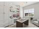 This stylish office includes custom built-ins, floating shelves and a unique chandelier, perfect for working from home at 10196 Sequoia Glen Ave, Las Vegas, NV 89166