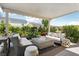 Inviting covered patio with comfortable seating, stylish decor, and views of the beautifully landscaped backyard at 10196 Sequoia Glen Ave, Las Vegas, NV 89166