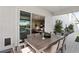 An outdoor dining area on the patio with stylish furniture and a view to the home's interior at 10196 Sequoia Glen Ave, Las Vegas, NV 89166