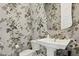 Charming powder room with floral wallpaper and a pedestal sink, creating a stylish and inviting space at 10196 Sequoia Glen Ave, Las Vegas, NV 89166