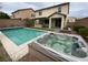 Inviting backyard featuring a pool, spa, covered patio, and low-maintenance landscaping perfect for outdoor entertaining at 10331 Northern Hills Ave, Las Vegas, NV 89166