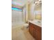 Bright bathroom features a tub/shower combo, toilet, vanity, tile flooring, and natural light from the window at 10331 Northern Hills Ave, Las Vegas, NV 89166
