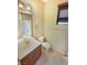 Bright bathroom featuring a single vanity, toilet, tile flooring, and natural light from the window at 10331 Northern Hills Ave, Las Vegas, NV 89166