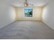 Spacious bedroom with neutral carpet, a ceiling fan and a bright window at 10331 Northern Hills Ave, Las Vegas, NV 89166
