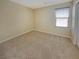 A carpeted bedroom with a large window and neutral wall color offers a cozy and inviting space at 10331 Northern Hills Ave, Las Vegas, NV 89166