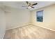 Neutral bedroom features carpet flooring, a ceiling fan, window, and ample natural light at 10331 Northern Hills Ave, Las Vegas, NV 89166