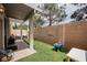 Private backyard with artificial turf, covered patio, seating area, and fully enclosed for outdoor enjoyment at 10400 Beautiful Fruit St, Las Vegas, NV 89183