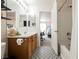 This bathroom offers unique flooring, wood vanity, shower and views to the adjacent bedroom at 10400 Beautiful Fruit St, Las Vegas, NV 89183