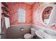 Stylish bathroom featuring flamingo wallpaper, toilet, sink and round mirror at 10400 Beautiful Fruit St, Las Vegas, NV 89183
