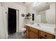 This bathroom offers unique flooring, wood vanity, and walk-in closet for ample storage space at 10400 Beautiful Fruit St, Las Vegas, NV 89183