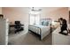 Cozy bedroom features a ceiling fan, a comfortable bed with blue pillows, and a desk area at 10400 Beautiful Fruit St, Las Vegas, NV 89183