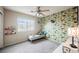 Cheerful bedroom with a vibrant accent wall, plush carpet, and plenty of natural light at 10400 Beautiful Fruit St, Las Vegas, NV 89183