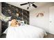 Comfortable bedroom features a decorative accent wall, neutral paint, and an inviting bed at 10400 Beautiful Fruit St, Las Vegas, NV 89183