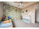 Vibrant bedroom features colorful wallpaper, plush carpet, and an inviting bed with stuffed animals at 10400 Beautiful Fruit St, Las Vegas, NV 89183