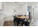 Modern dining room featuring a wood table and chairs, and decorative lighting fixture at 10400 Beautiful Fruit St, Las Vegas, NV 89183