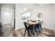 Bright dining area features stylish chairs, wood table, and an open view into the kitchen at 10400 Beautiful Fruit St, Las Vegas, NV 89183