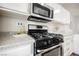 Well-equipped kitchen features a stainless steel gas range and microwave at 10400 Beautiful Fruit St, Las Vegas, NV 89183