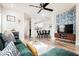 Open living room with wood-look floors, ceiling fan, modern decor, and view of the dining and kitchen at 10400 Beautiful Fruit St, Las Vegas, NV 89183