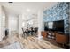 Open living room featuring wood-look floors, modern decor, a view of the dining area and kitchen at 10400 Beautiful Fruit St, Las Vegas, NV 89183