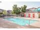 Community pool and lounge area with nearby residential buildings at 10400 Beautiful Fruit St, Las Vegas, NV 89183