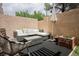 Outdoor seating area with comfortable lounge furniture, decorative planters, and shade umbrella at 10400 Beautiful Fruit St, Las Vegas, NV 89183