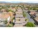 Charming community with tile-roofed houses, lush trees, and a rooftop deck for relaxing outdoors at 10565 Olinda St, Las Vegas, NV 89179