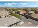 Residential aerial shot featuring houses with tiled roofs and desert landscaping under a clear blue sky at 10565 Olinda St, Las Vegas, NV 89179