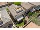 Backyard aerial view featuring a cozy patio, synthetic grass, and a rooftop deck ready for entertaining at 10565 Olinda St, Las Vegas, NV 89179