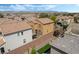 Backyard aerial view with desert landscaping, a covered patio, and secure brick wall at 10565 Olinda St, Las Vegas, NV 89179