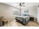 Cozy bedroom features hardwood floors, a ceiling fan, and a window with wooden shutters at 10565 Olinda St, Las Vegas, NV 89179