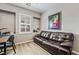 Cozy den features a comfortable sofa and window with plantation shutters at 10565 Olinda St, Las Vegas, NV 89179