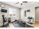 Exercise room featuring a ceiling fan, window shutters, hard flooring, and various workout equipment at 10565 Olinda St, Las Vegas, NV 89179