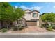 Charming two-story home with a well-manicured front yard and brick driveway at 10565 Olinda St, Las Vegas, NV 89179