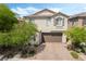 Charming two-story home showcasing a well-maintained yard and a welcoming two-car garage at 10565 Olinda St, Las Vegas, NV 89179