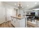 Open kitchen with white cabinets, stainless steel appliances, and a view of the living room at 10565 Olinda St, Las Vegas, NV 89179