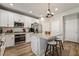 Modern kitchen with white cabinets, stainless steel appliances, and a granite countertop island at 10565 Olinda St, Las Vegas, NV 89179