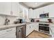 Modern kitchen with white cabinets, stainless steel appliances, and granite countertops at 10565 Olinda St, Las Vegas, NV 89179