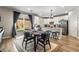 Bright kitchen with white cabinets, stainless steel appliances, and a sliding glass door to the yard at 10565 Olinda St, Las Vegas, NV 89179